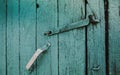 Door latch on green painted barn doors. Royalty Free Stock Photo