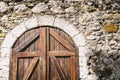 Wooden Door of an mediterranean house with rustic stone wall. Royalty Free Stock Photo