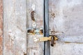 Old dilapidated door closed with padlock