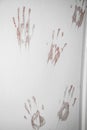 The door is stained with traces of bloody hands.