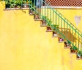 door and stairs on yellow wall Royalty Free Stock Photo