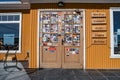 Door with stickers to a cafeteria at Punta Delgada where is a ferry going through Strait of Magellan, Tierra del Fuego, Patagonia