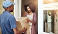 Door to door delivery. a postal worker delivering a package to a young female customer. Royalty Free Stock Photo
