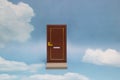 Door to new world. Close door on blue sunny sky with fluffy clouds. Royalty Free Stock Photo