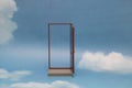 Door to new world. Open door on blue sunny sky with fluffy clouds. Royalty Free Stock Photo