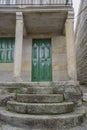 Door under some arcades with columns and on some stone stairs in Combarro, a parish belonging to the municipality of Poio