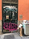 Door vandalized with graffiti in a street in the center of Madrid.
