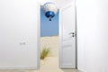 Door between worlds. Sand is poured through doorway, hot air balloons flies through door into room.