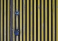 Door with yellow vertical stripes closeup .