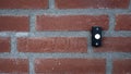 Doorbell button on a stone exterior wall
