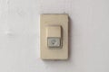 Doorbell or buzzer on gray wall