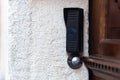 Doorbell with remote door opening near the vintage door, in the old part of town Royalty Free Stock Photo