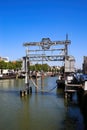 View on old shipyard sign in typical dutch inland water canal harbor focus on grey construction