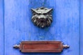 Doorknocker and letter box on a blue wooden door Royalty Free Stock Photo