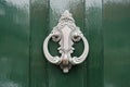 Doorknocker in silver on green painted wooden door Royalty Free Stock Photo