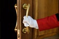 The doorman opens the hotel door hands in white gloves Royalty Free Stock Photo