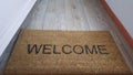 A doormat saying welcome
