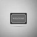 Doormat with the text Welcome icon isolated on grey background. Welcome mat sign. Flat design. Vector