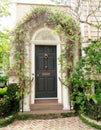 Doors with brick archway covered in green vines in Charleston, South Carolina