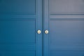 Doors with handles. Blue, white, grey. Wardrobe in the apartment. Style. MAcro.