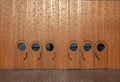 Doors with round windows portholes in a wooden high wall on a ship deck