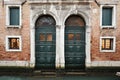 Doors and windows over canal in Venice, Italy Royalty Free Stock Photo