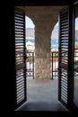 Doors with wooden blinds on the window on a large balcony