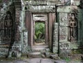 Doorway through the ancient temples of Angkor, statues on the side of the door