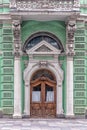 Doorway with a carved wooden door on the facade of the building