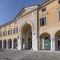 Doorway at Classical arcade on cobbled square in historical town, Rovato, Italy Royalty Free Stock Photo