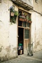 Doorway with flowers, dog and pushcart