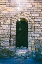 The doorway in the fortress to the ruins of an ancient city in the sunlight. Royalty Free Stock Photo