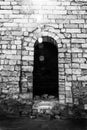 the doorway in the fortress to the ruins of an ancient city in the sunlight, black and white photo Royalty Free Stock Photo