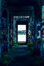 A doorway through graffiti cover columns Royalty Free Stock Photo