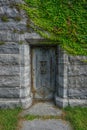 The doorway of an ivy-covered stone crypt in the Sleepy Hollow Cemetery