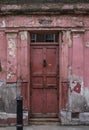 Doorway, part of the exterior of red painted traditional Huguenot weaver`s house on Princelet Street, Spitalfields, East London