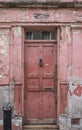 Doorway, part of the exterior of red painted traditional Huguenot weaver`s house on Princelet Street, Spitalfields, East London