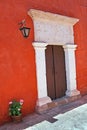 Doorway in colourful wall with lantern