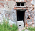 Doorway in the red brick wall of a ruined house Royalty Free Stock Photo