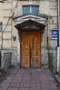 Doorway of stone house facade. Architecture of European city. Retro building exterior