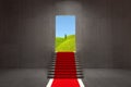 Doorway to nature. Red carpet stairway from concrete room interior to ecologycal nature