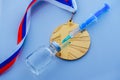 Doping in Sport, concept photo, syringe, medical ampoule and gold medal