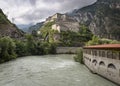 Dora Baltea river in Hone town and a view of the Bard fortress