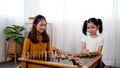 A dorable Asian sisters and sisters are happily lounging in the kitchen with the joy and warmth they give Royalty Free Stock Photo