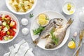 Dorada fish sea bream baked, fresh vegetable greek salad, boiled potatoes with garlic and olives and tzatziki dip. Healthy food