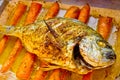 Dorade with curry on carrots in oriental style