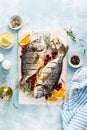 Dorado fish grilled with oranges, cranberries and rosemary, Mediterranean food. Christmas festive healthy dinner, top view