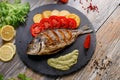 Dorado fish with potatoes and tomatoes