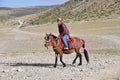 Dorchen, Tibet, China. People riding a horse making parikrama around Kailas in Tibet