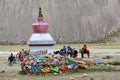 Dorchen, Tibet, China, June, 18, 2018. Pilgrims near the white Buddhist stupa at the beginning of the Cora around Kailas